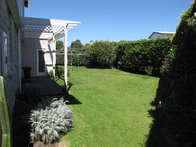 Partly fenced backyard for kids to play