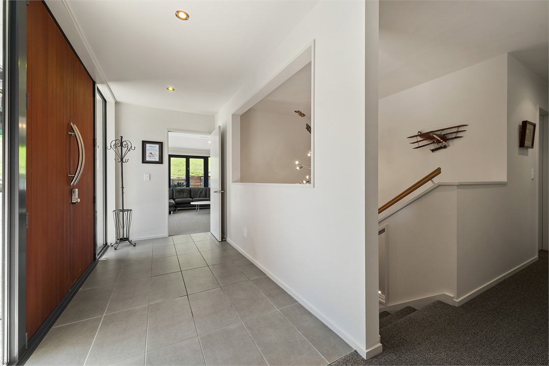 A welcoming foyer leading to living in one wing, a