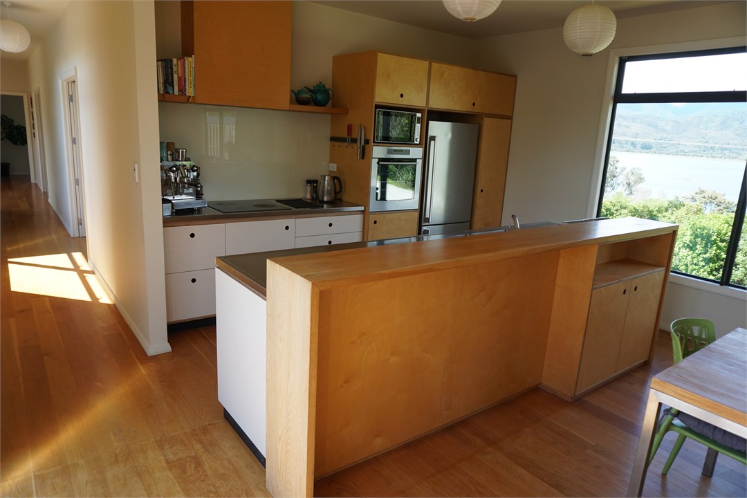 Kitchen overlooks estuary and opens to generous ou