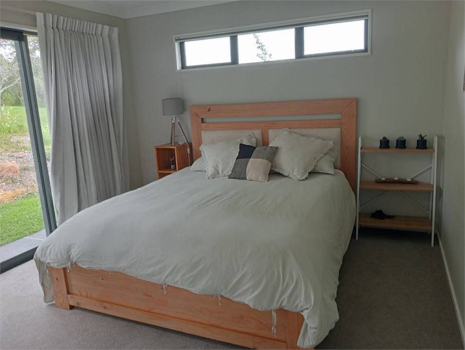 King bed beside separate toilet