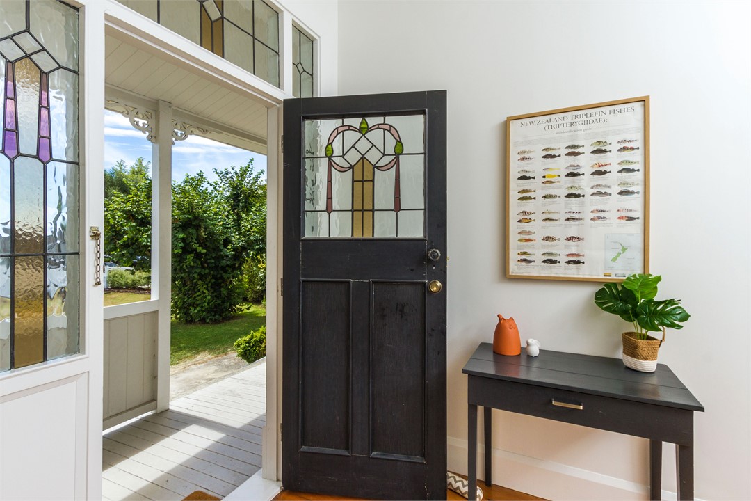 Front door opening to sunny front deck & lawn