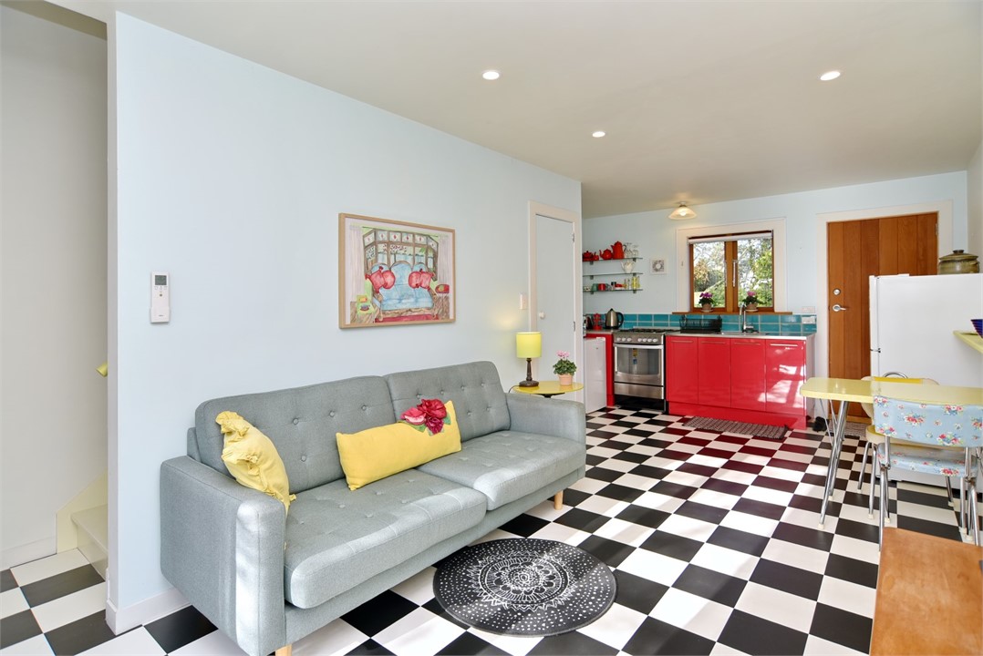 Living room with a seating area and a TV