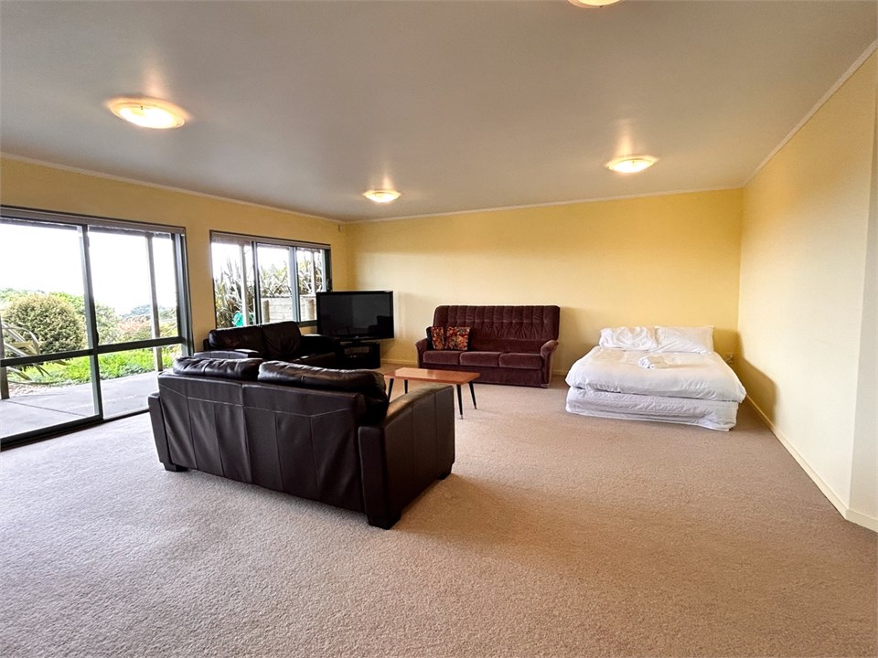 Downstairs living area with tv - and Double bed in