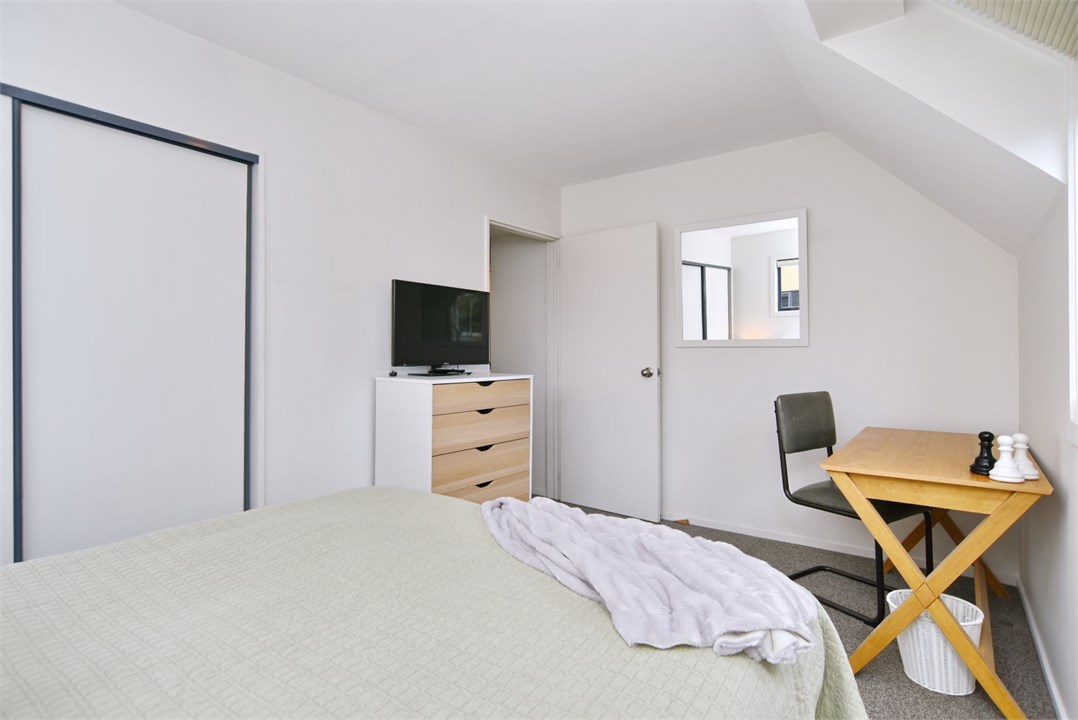 Bedroom 2 has a Queen bed and a TV