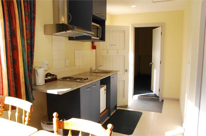 The Barn - kitchenette and door to Annex