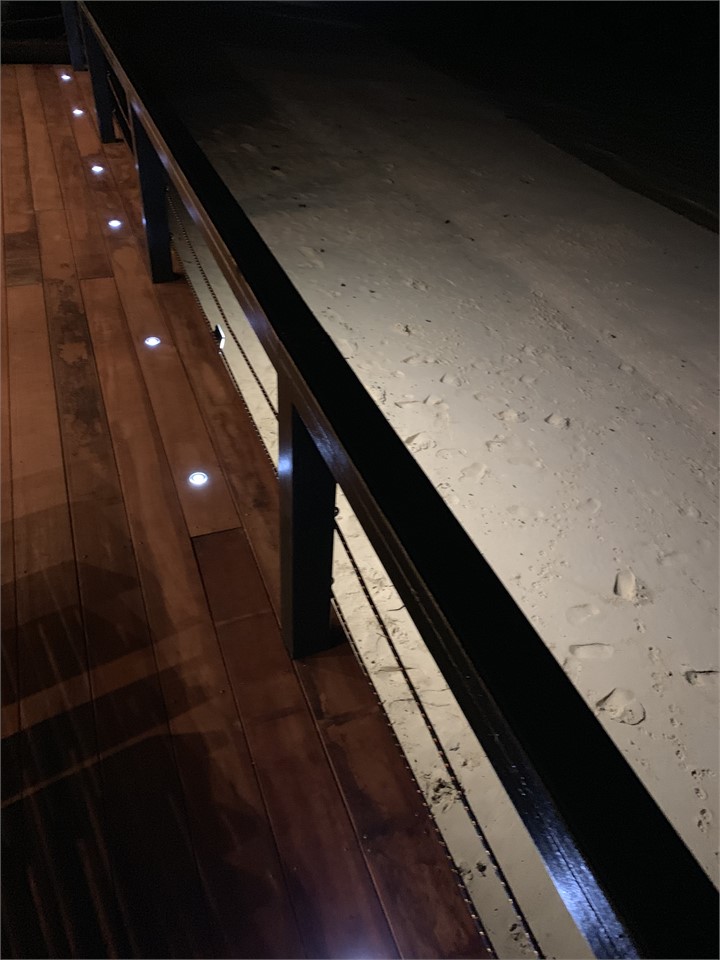 View of the beach with the deck lighting
