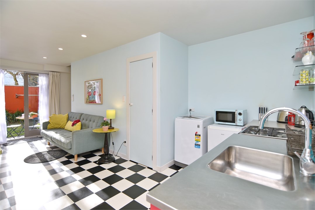 Living room with a seating area and a TV