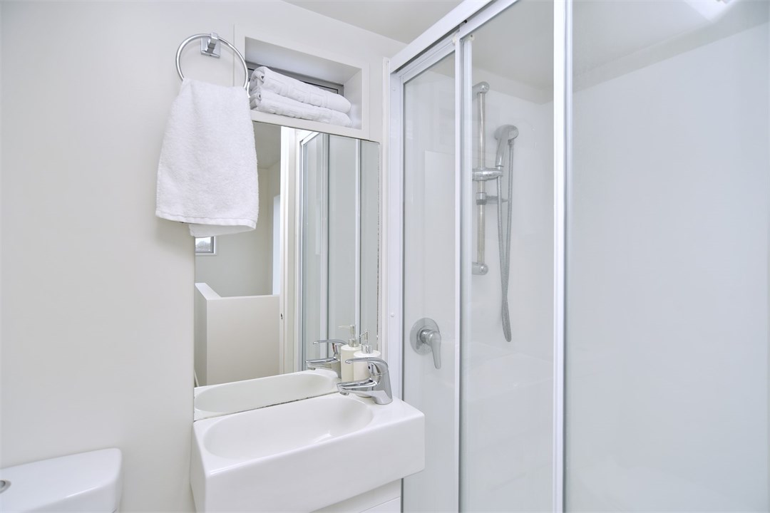 Bathroom 1 has a shower and a toilet