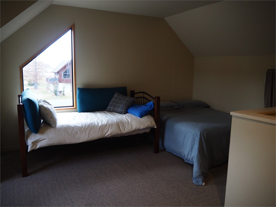 Single bed and double bed in the open upstairs bed