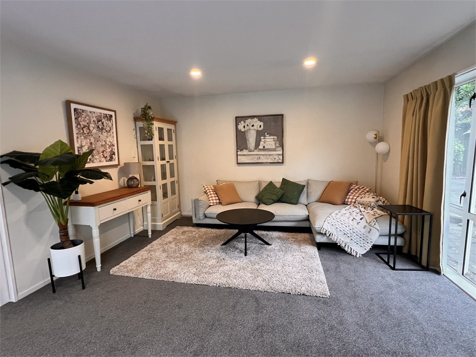 Living room with a TV and seating areas