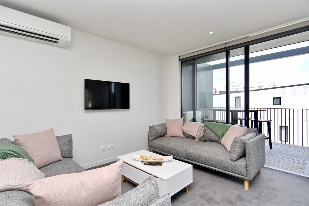 Living room has a TV and seating areas