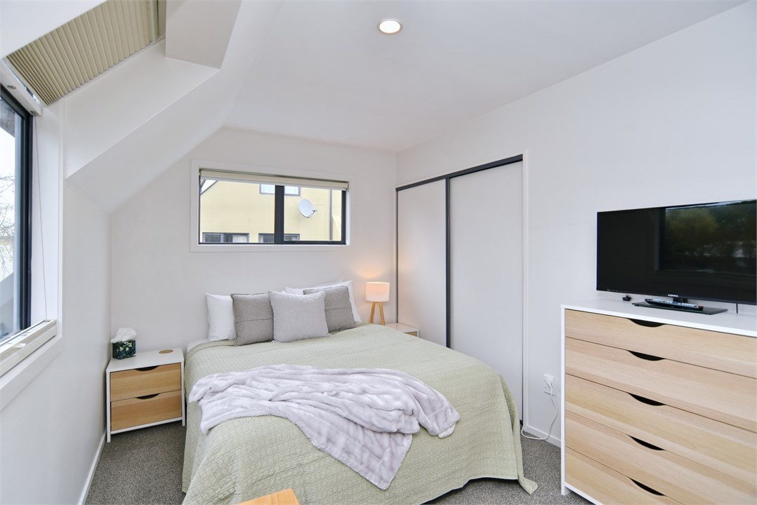 Bedroom 2 has a Queen bed and a TV