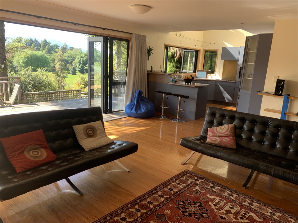 Kitchen links with lounge, dining and decks.