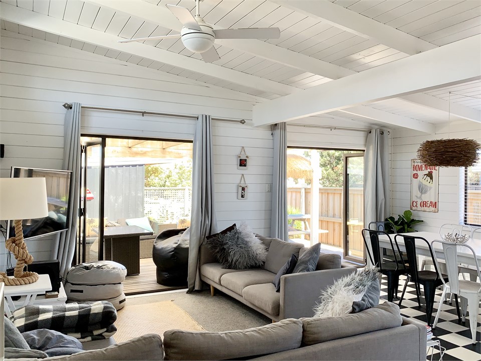 Bifold doors lead out out to the sunny deck and fr