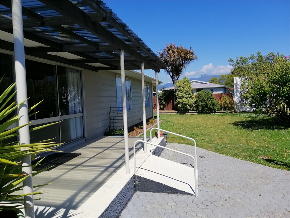 Fenced northern lawn with covered patio