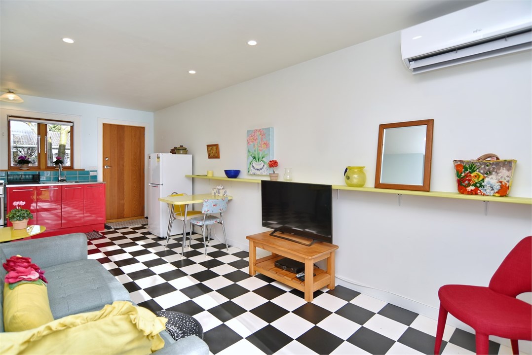 Living room with a seating area and a TV
