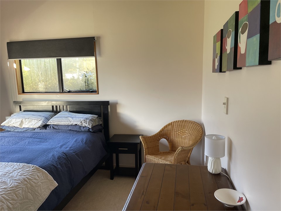 Large room with built in wardrobe and local art.