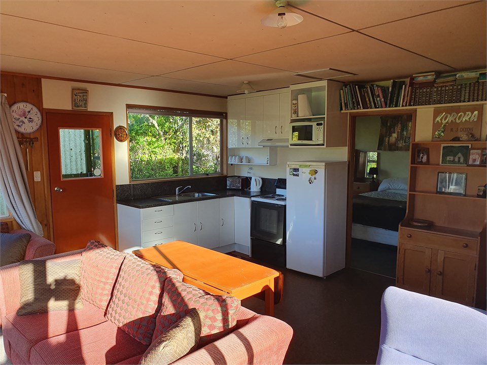 Main room showing kitchen & main bedroom door