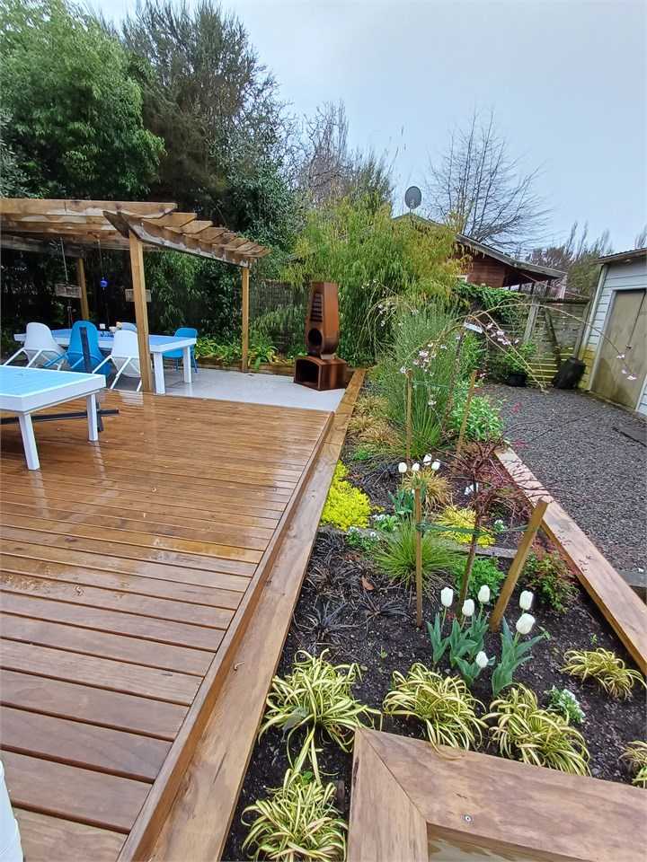 Backyard entertaining area. Sping growth starting 