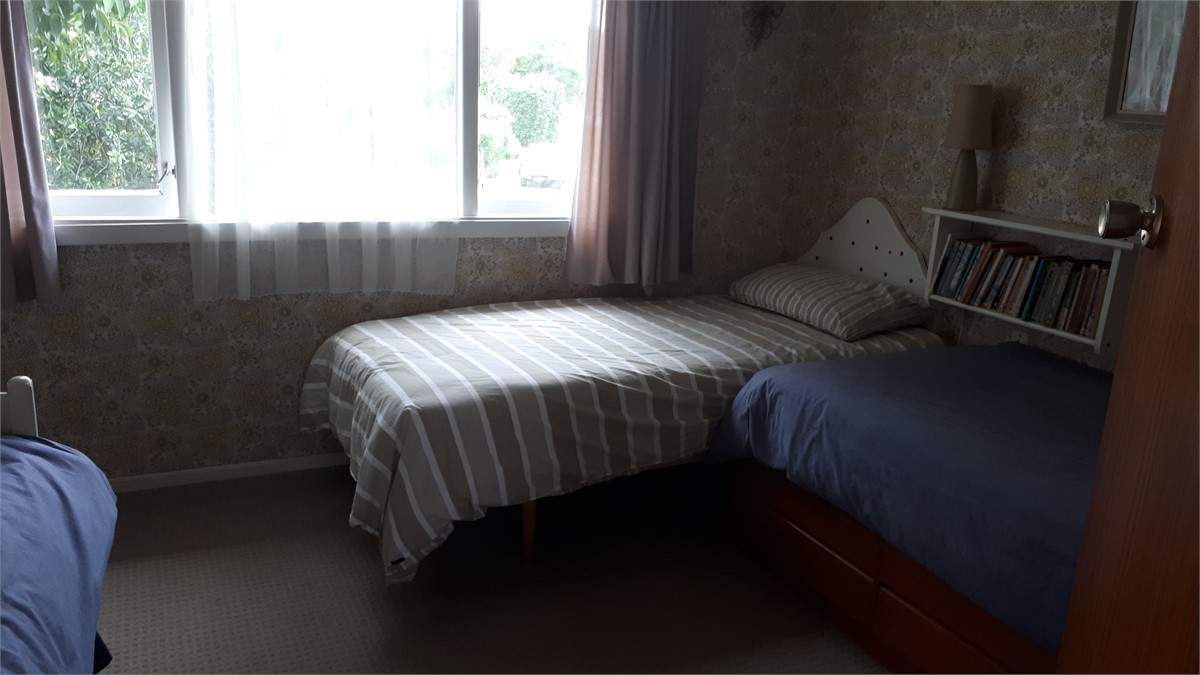 Upstairs bedroom with three single beds