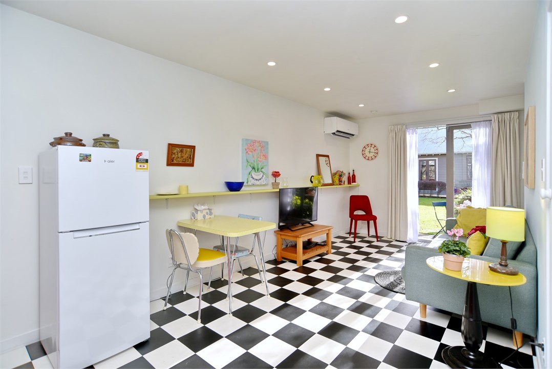 Living room with a seating area and a TV