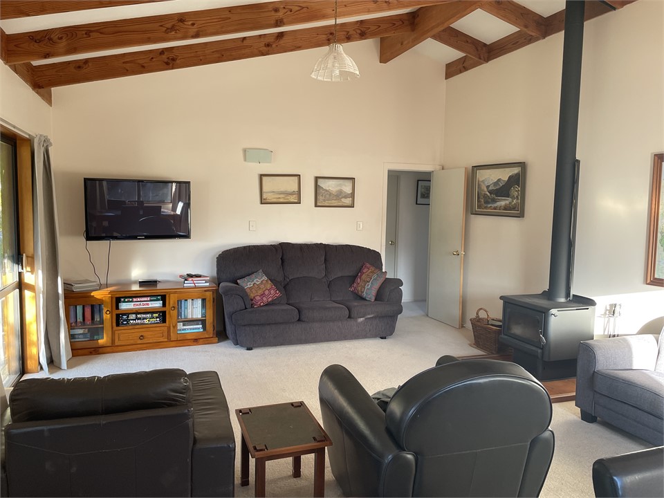 Log burner heats the house with tv, books and game