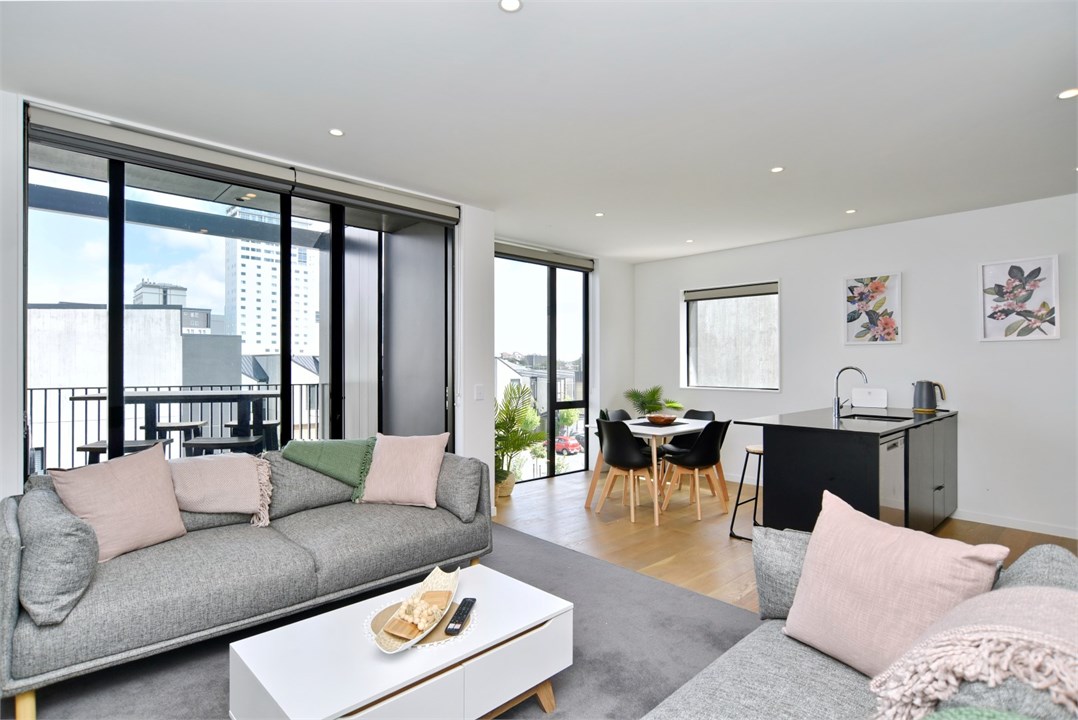 Living room has a TV and seating areas