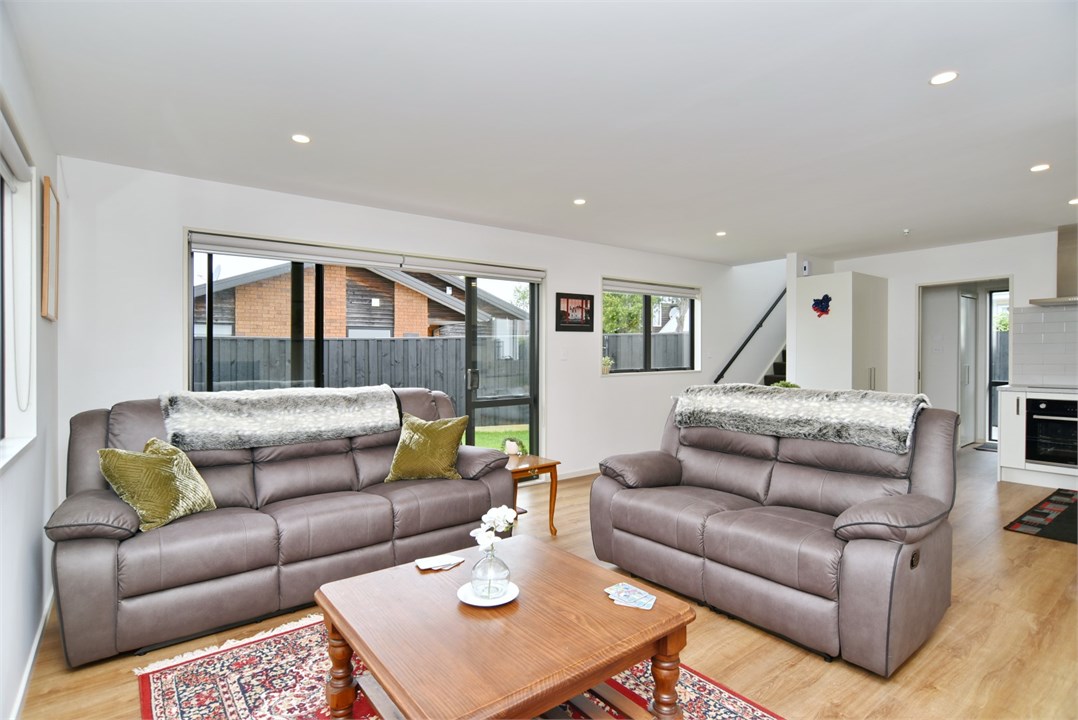 Living room has a TV and seating areas