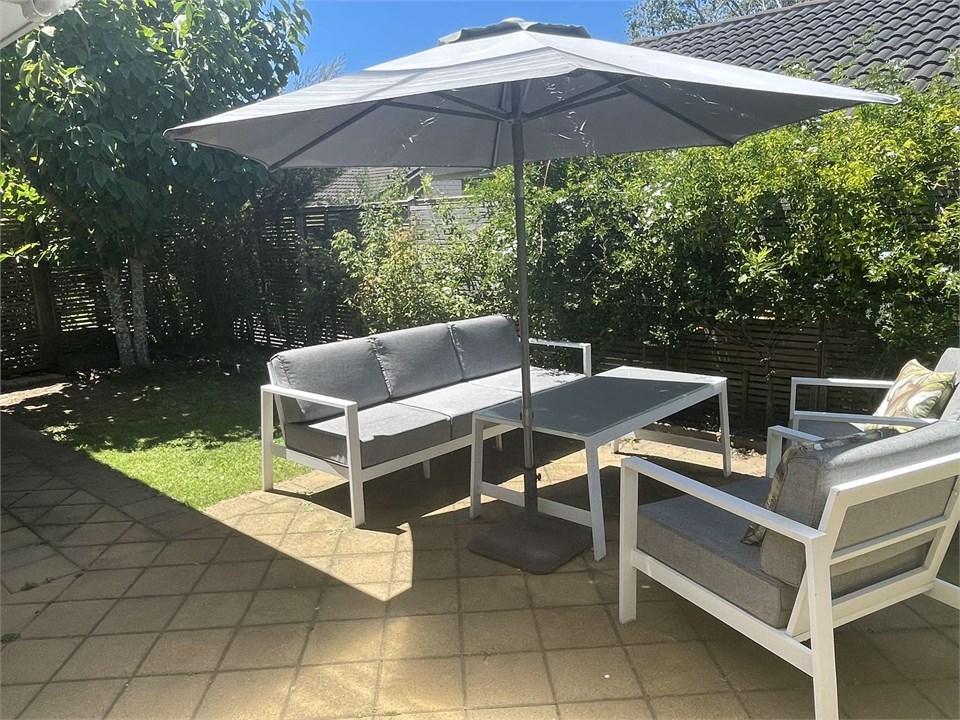 Outdoor setting beside covered BBQ