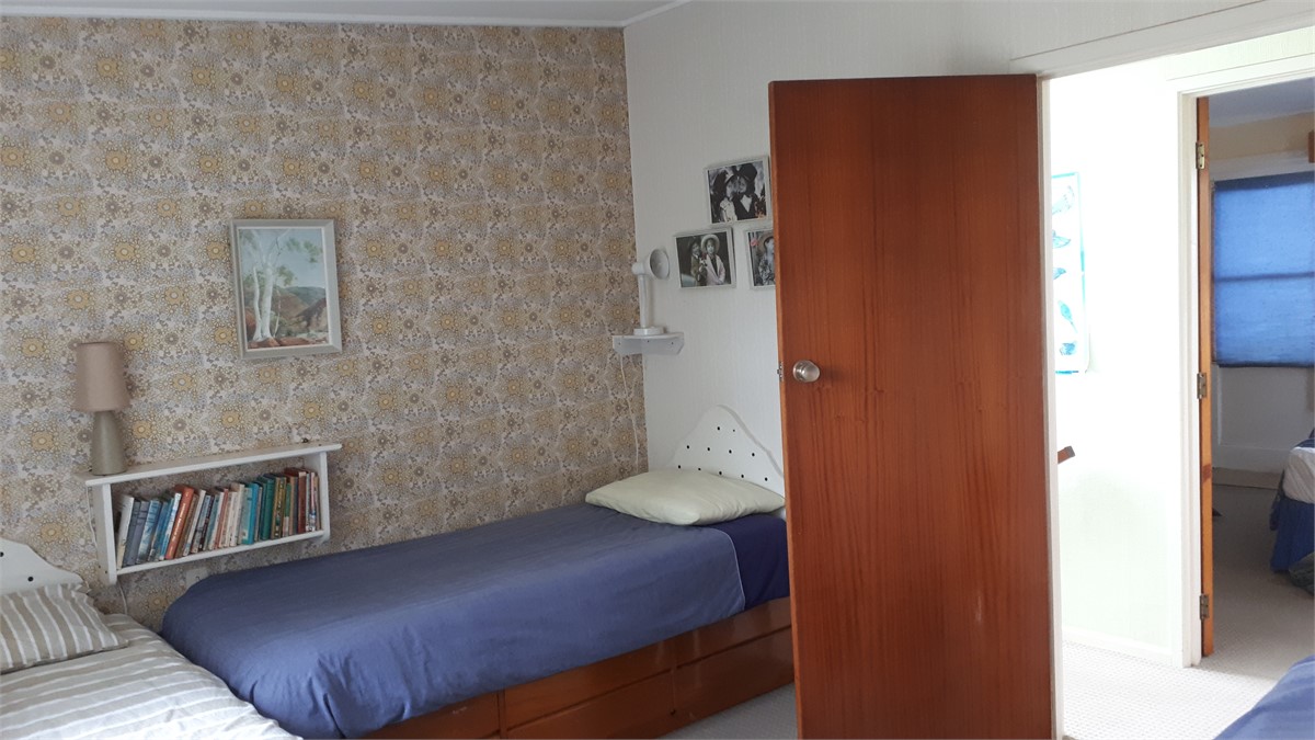 Another view of bedroom with three single beds.