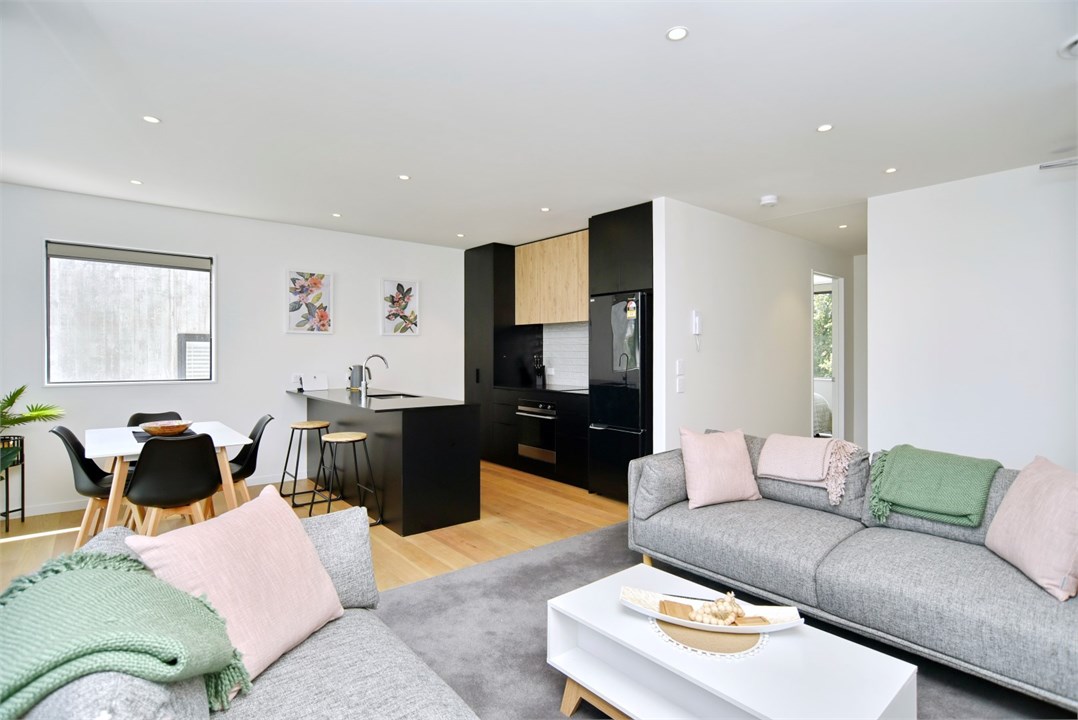 Living room has a TV and seating areas