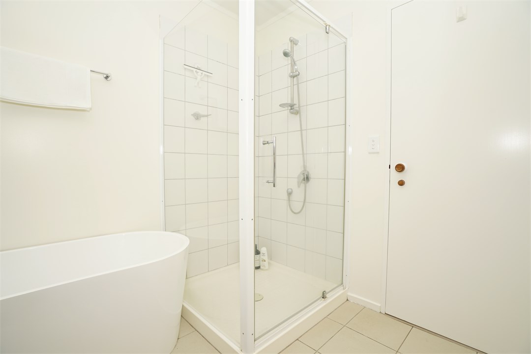 Bathroom has a shower and a bathtub