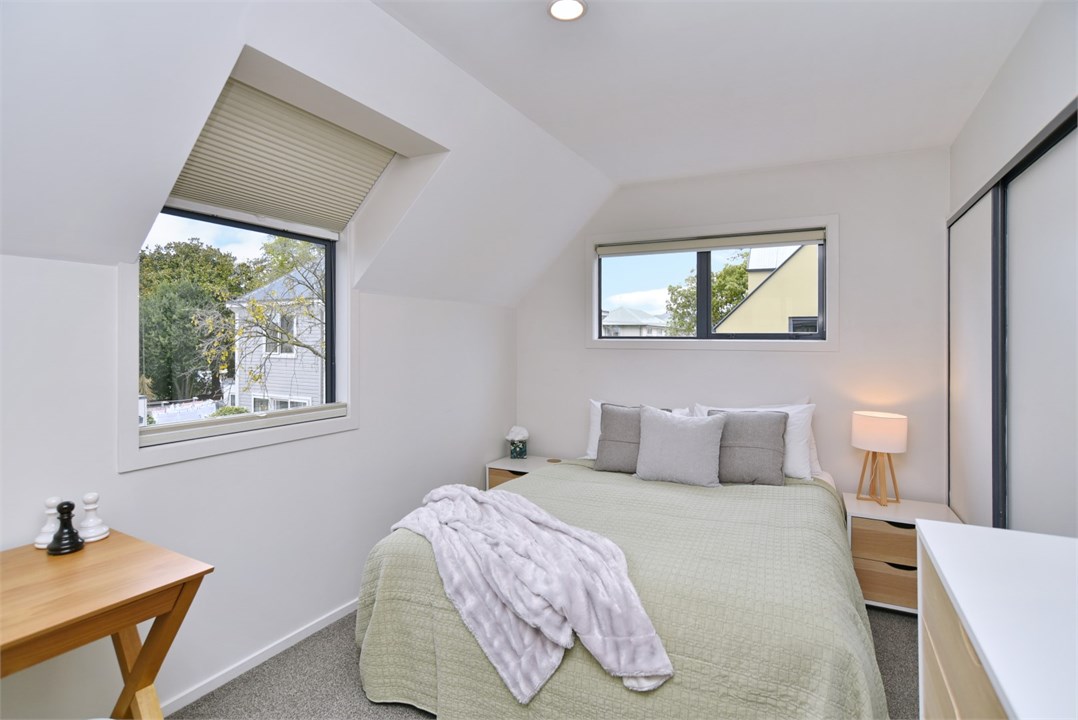 Bedroom 2 has a Queen bed and a TV