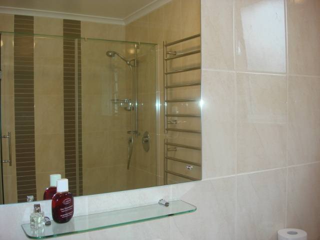 Bathroom with long shower and toilet