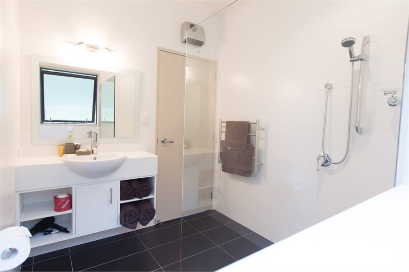 Bathroom with shower, heater and shampoo etc.
