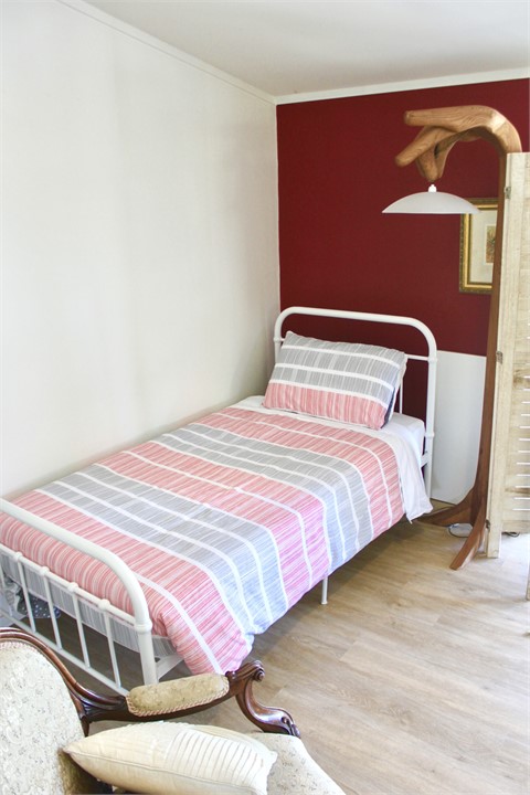 Single bed in cottage lounge (screened)
