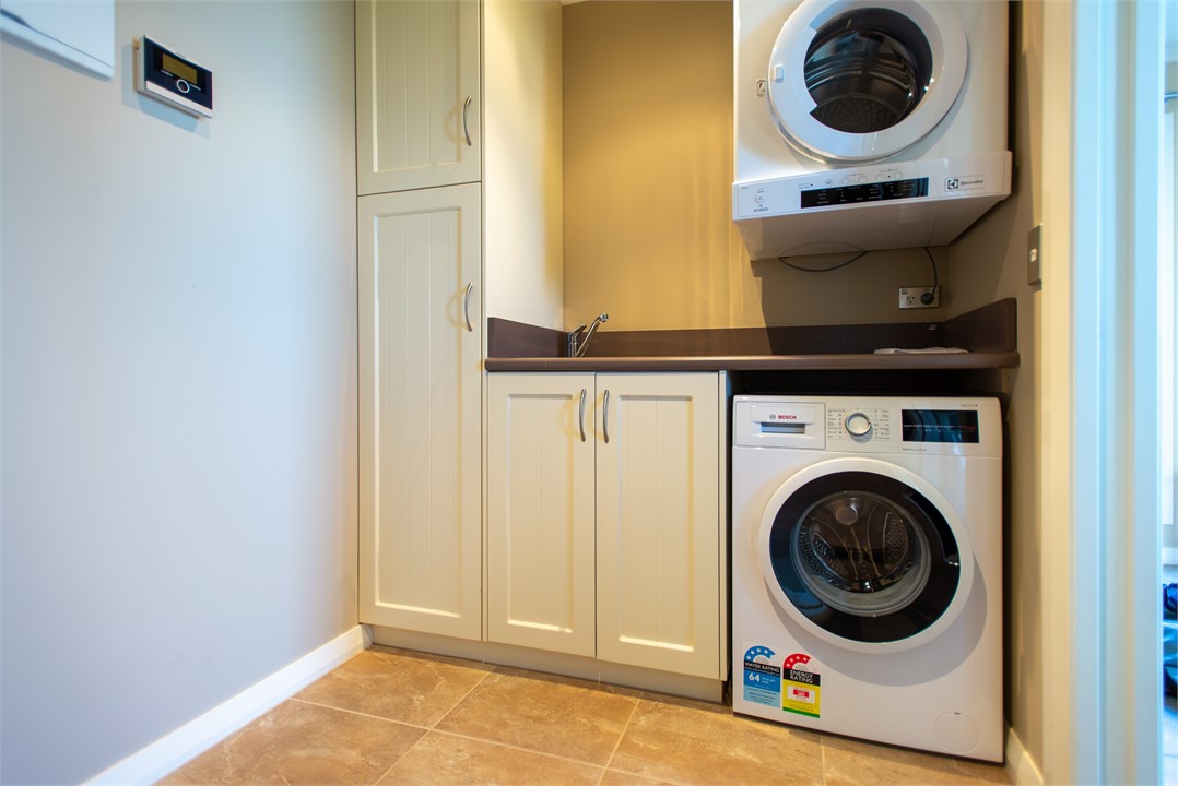 Laundry with Washing Machine, Dryer & Ironing