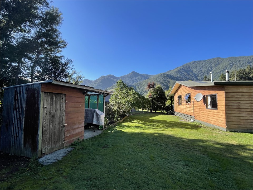 Back garden with woodshed and fish cleaning area.