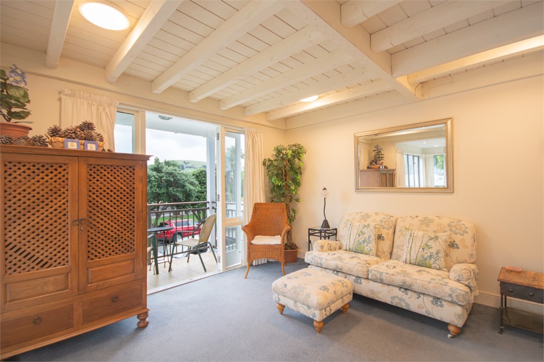 Living room has a TV and seating areas