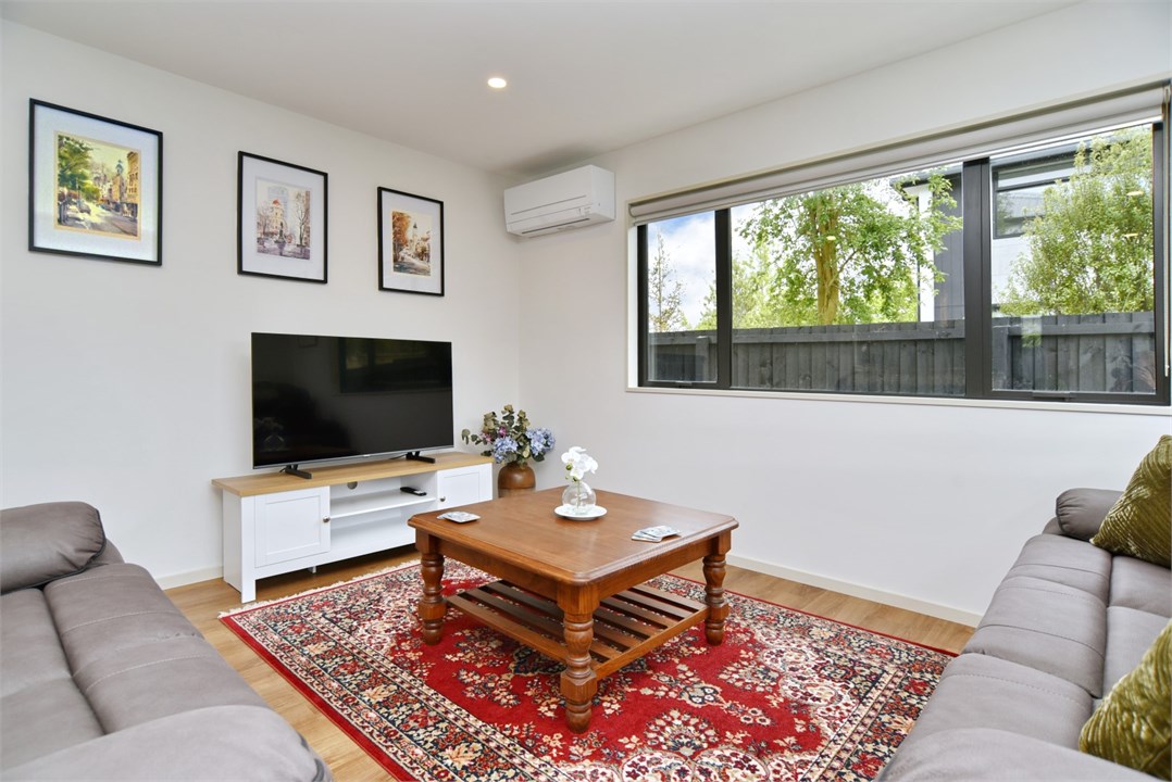 Living room has a TV and seating areas