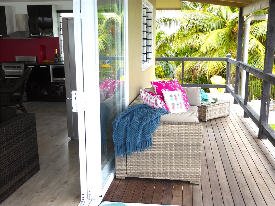 the deck / balcony has couch , seating & BBQ