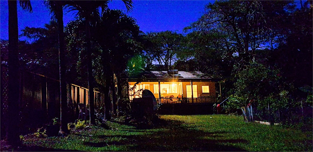 Looking up from beach to house at night