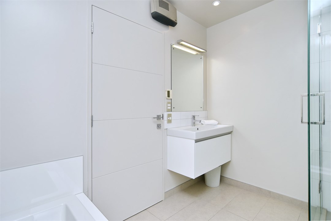 Bathroom 2 has a shower, toilet and a bath