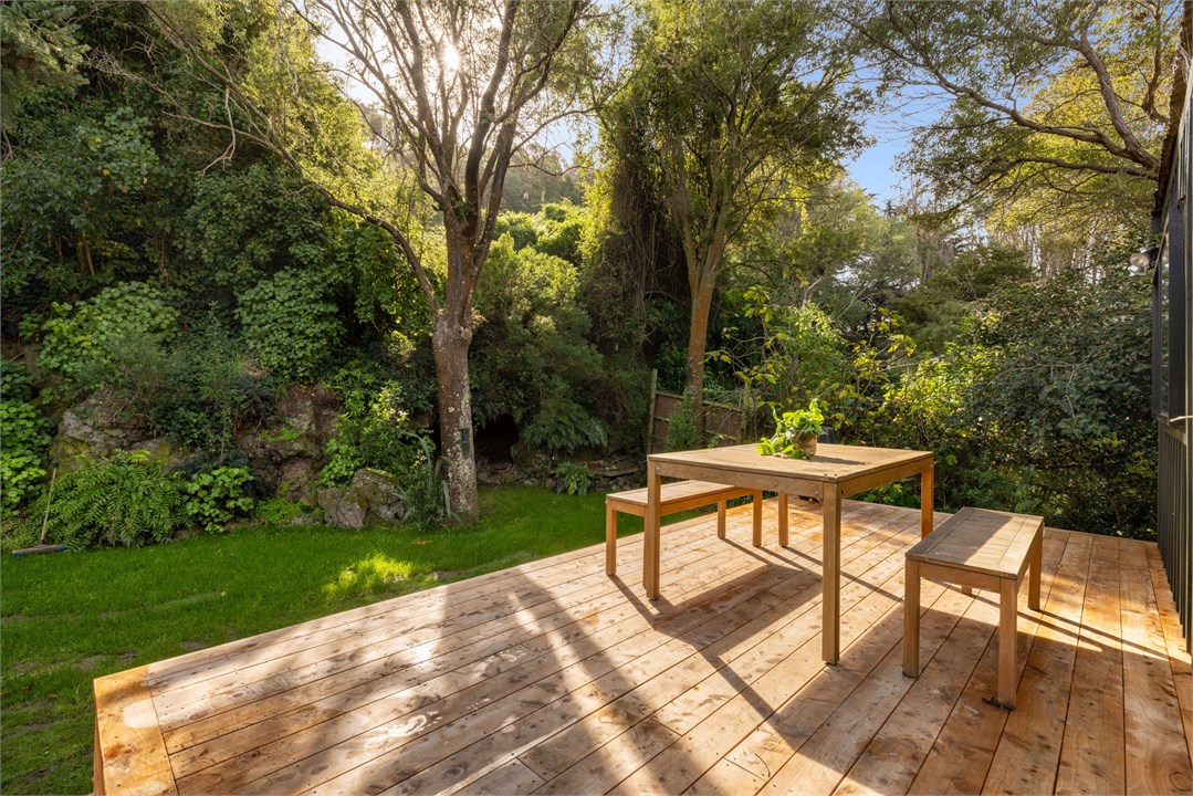 Sunny deck area with built in BBQ area, fire pit a