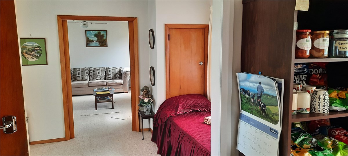 Standing in kitchen looking through the two loung