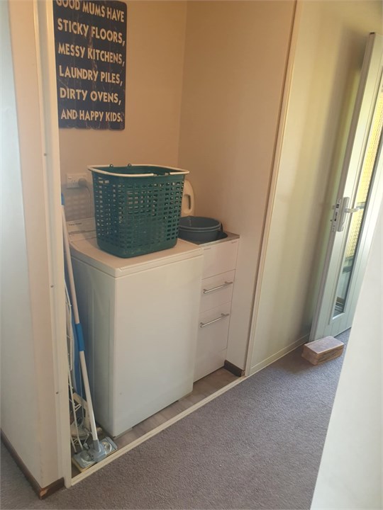 Laundry alcove behind a sliding door