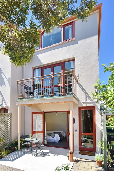 Outdoor seating area and Bedroom 2 through doors