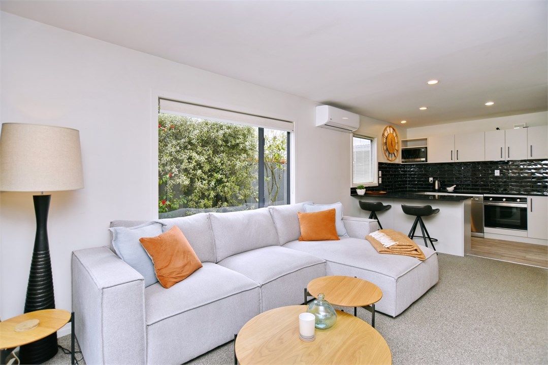 Living room has a TV and seating areas