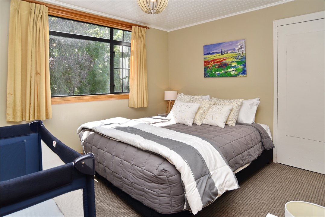 Bedroom 4 has a Queen bed and a cot / crib