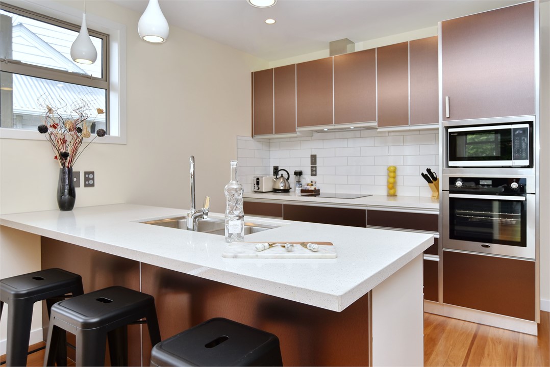 The sleek modern kitchen is fully-equipped with co